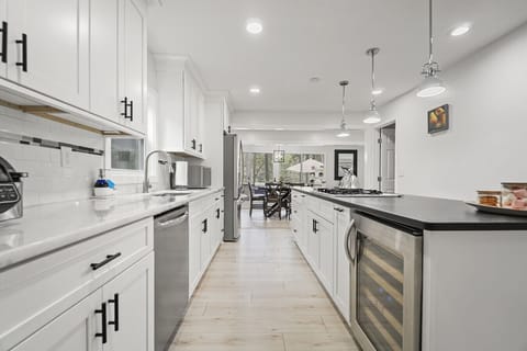 Kitchen | Modern White Cabinetry, Large Island with Seating, and Stainless Steel Appliances