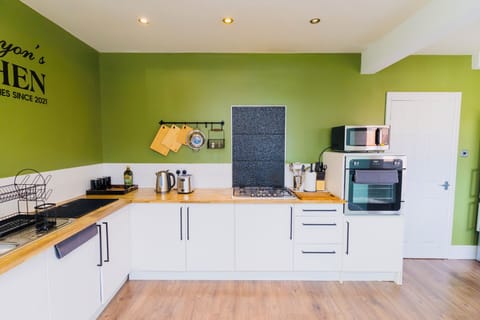 Chopping boards, kettle, toaster, tea, coffee, sugar, olive oil