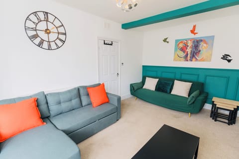 Green 3 seater click clack sofa & offers 45 degrees - great for movie night!