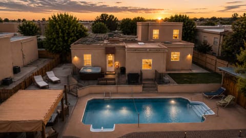Pool, shaded loungers, and a hot tub for evening soaks.