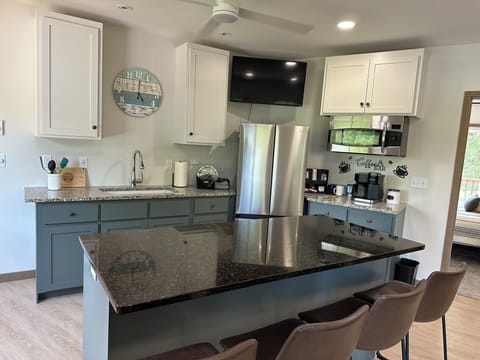 Upstairs kitchen with refrigerator, microwave and coffee area