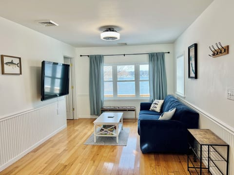 Living room with view of Pretty Lake, smart TV, and board games