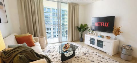 Bright living room with floor-to-ceiling windows and beautiful Biscayne Bay views.