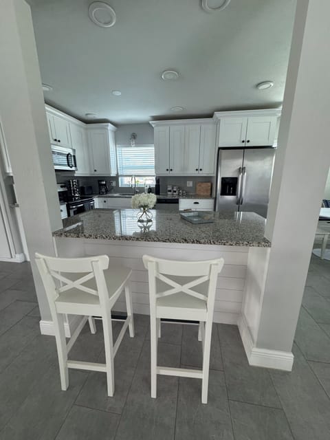 Open kitchen with island and high chairs
