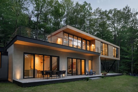 Modern architectural home with floor to ceiling windows to enjoy nature.