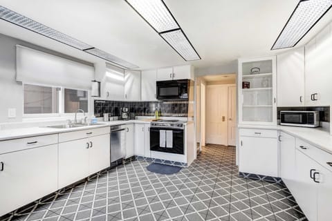 Whip up meals with ease in the spacious full kitchen, featuring stainless steel appliances, plenty of counter space, and all the essentials for your stay..

