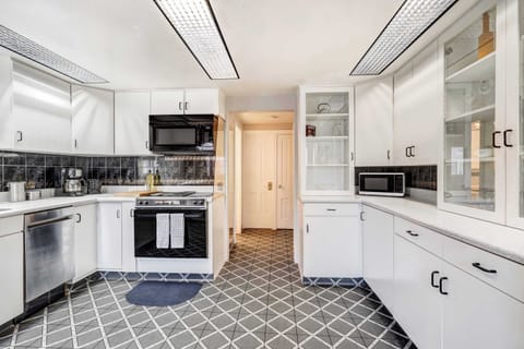 Whip up meals with ease in this bright, fully equipped kitchen featuring modern appliances, ample counter space, and classic cabinetry.







