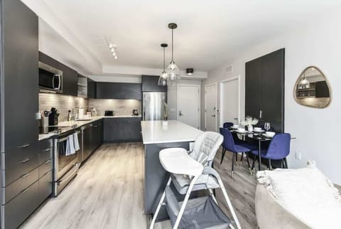 Fully equipped kitchen with a breakfast counter (seats 3) and a dining area (seats 4), plus a high chair available for little ones.