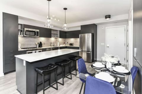 Fully equipped kitchen with a breakfast counter (seats 3) and a dining area (seats 4), plus a high chair available for little ones.