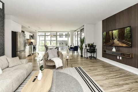 Chic and bright living room with cozy couch, flatscreen Tv and dedicated work station