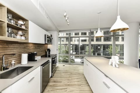 Fully equipped kitchen with a breakfast counter (seats 3) and a dining area (seats 4), plus a high chair available for little ones.