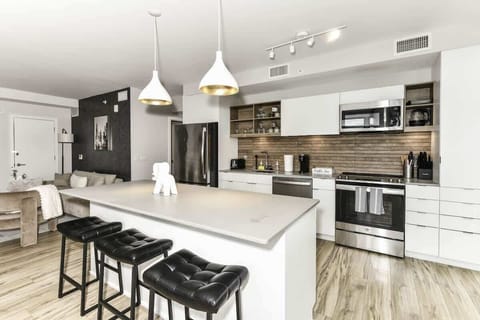 Fully equipped kitchen with a breakfast counter (seats 3) and a dining area (seats 4), plus a high chair available for little ones.