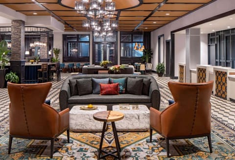 Cozy lobby with sofa, chairs, and bright chandeliers