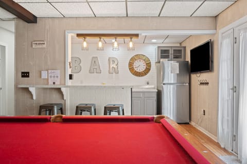 Challenge friends to a game of pool at the bar in this fun-filled game room