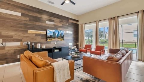 Elegant living room with a rustic wood-planked accent wall and luxurious leather seating.