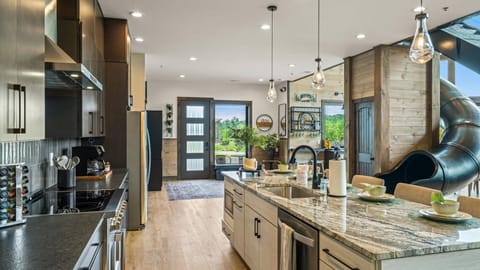 Cook, gather, and slide into fun in this open-concept kitchen