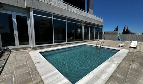 Dive into sunlit serenity with a sparkling rooftop pool.