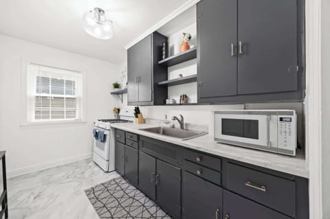 Kitchen: Unit 1 - Cook with ease in this functional kitchen featuring updated appliances and essentials.