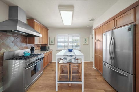 Spacious kitchen with modern appliances and a cozy island, perfect for family gatherings and culinary adventures.