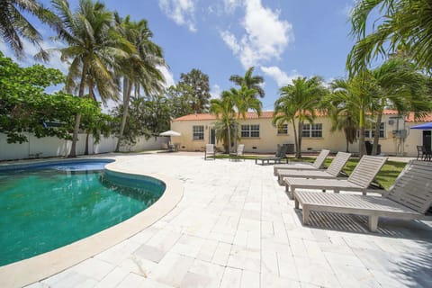 Relax by your private pool oasis surrounded by lush palms and enjoy the sun on comfortable loungers. Perfect for unwinding in a tropical paradise.