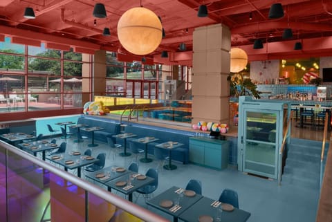 Colorful dining area with bar seating and pool view