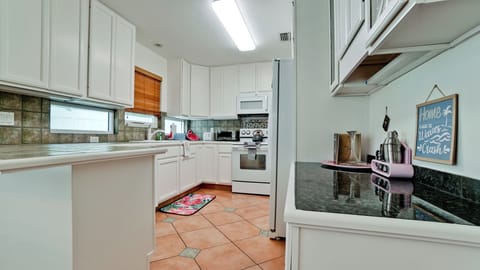 Kitchen with lots of dishes and cooking items.