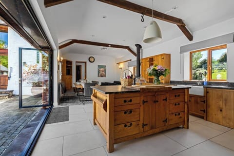 Kitchen island and bifold doors into the courtyard. A stunning and luxury social space! (1)