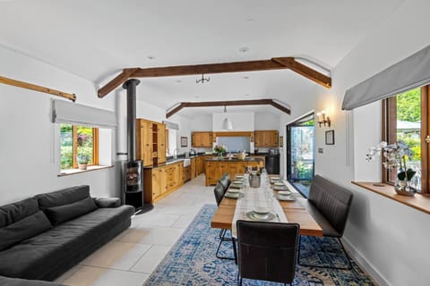 Fully equipped luxury kitchen. Large table that comfortable seats 12. Modern fireplace, island 360 garden views. Bifold doors that open onto your private courtyard area. Large sofa to make the kitchen a beautiful social area. 