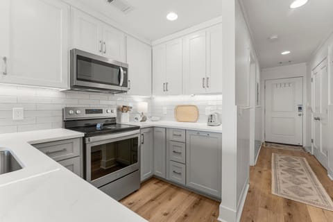 The fully equipped kitchen features quartz countertops, stainless-steel appliances, and has everything you need to prepare meals.