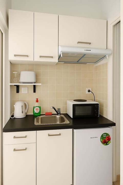 A modern kitchenette equipped with everything you need for a comfortable stay.
