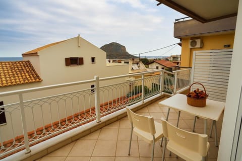 A bright balcony with seating, perfect for enjoying sea views and sunsets.

