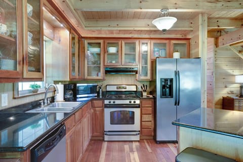 Modern kitchen with stainless steel appliances and a gas stove.