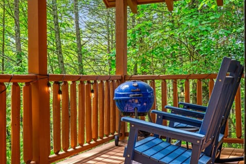 Relax on the private deck with bistro table, rocking chairs, charcoal grill