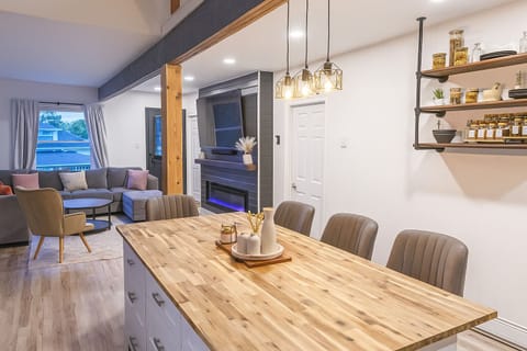 Spacious kitchen with island seating, open to living area with modern fireplace