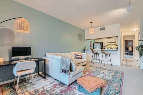 Enjoy a versatile space with a dedicated desk for work, a cozy living room for relaxing, and a bright, fully equipped kitchen for all your cooking needs.