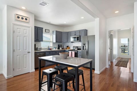 A bar top table provides additional seating next to the kitchen