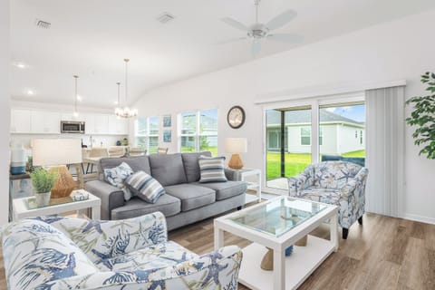 Open Concept: Living Room, Dining and Kitchen with an Abundance of Windows for Natural Light. Screened-in Lanai off of the Living Room