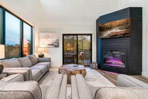 On the main level you have a modern living room, with Smart TV, comfortable seating, and electric fireplace.