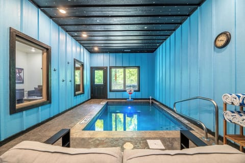 Your own private indoor pool awaits with smooth stone edges, warm lighting, and a view of the greenery outside—perfect for relaxing swims anytime.