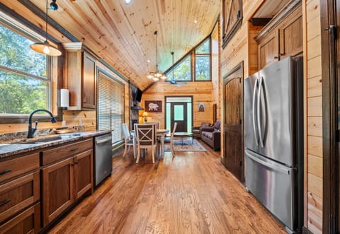 Enjoy a fully stocked kitchen with stainless appliances, gorgeous wood finishes, and an open-concept layout that flows into a comfy living space.