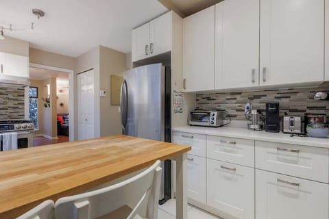 Prepare delicious meals in style with ample space, top-notch appliances, and a cozy breakfast bar.