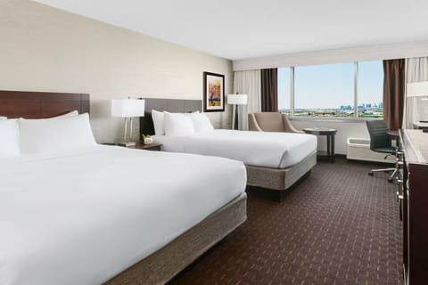 Settle into two cloud-soft beds with a skyline view.