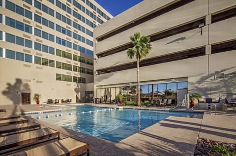 Dive into a sparkling courtyard pool framed by city views.