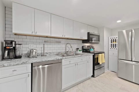 Modern Appliances: The kitchen features sleek, stainless steel appliances, including a state-of-the-art oven and microwave, ensuring a convenient cooking experience.