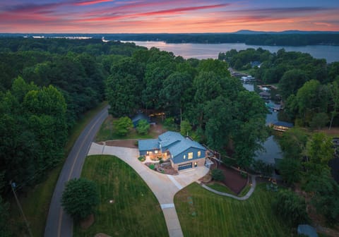 Aerial view of the house, yard, and lake.