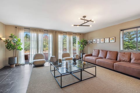 Features a large Smart TV, two soft plush covered chairs, and two accent table — perfect for morning coffee, reading, or planning your day's activities.