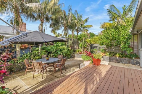 The backyard area has lovely outdoor seating in the garden.