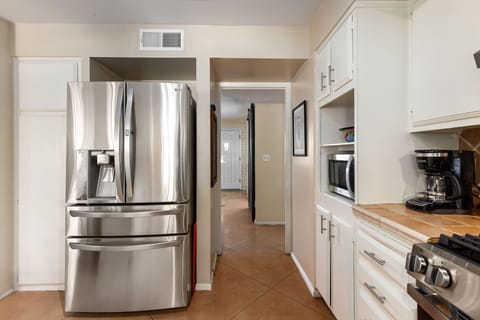 Chill drinks, store snacks—fridge with water dispenser & pantry cabinet.