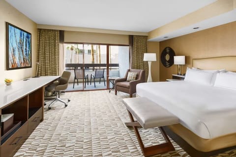 Unwind in a spacious king room with balcony daylight.