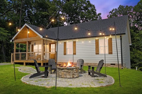 Step into your cozy retreat where evenings come alive with a crackling firepit and magical string lights at twilight.